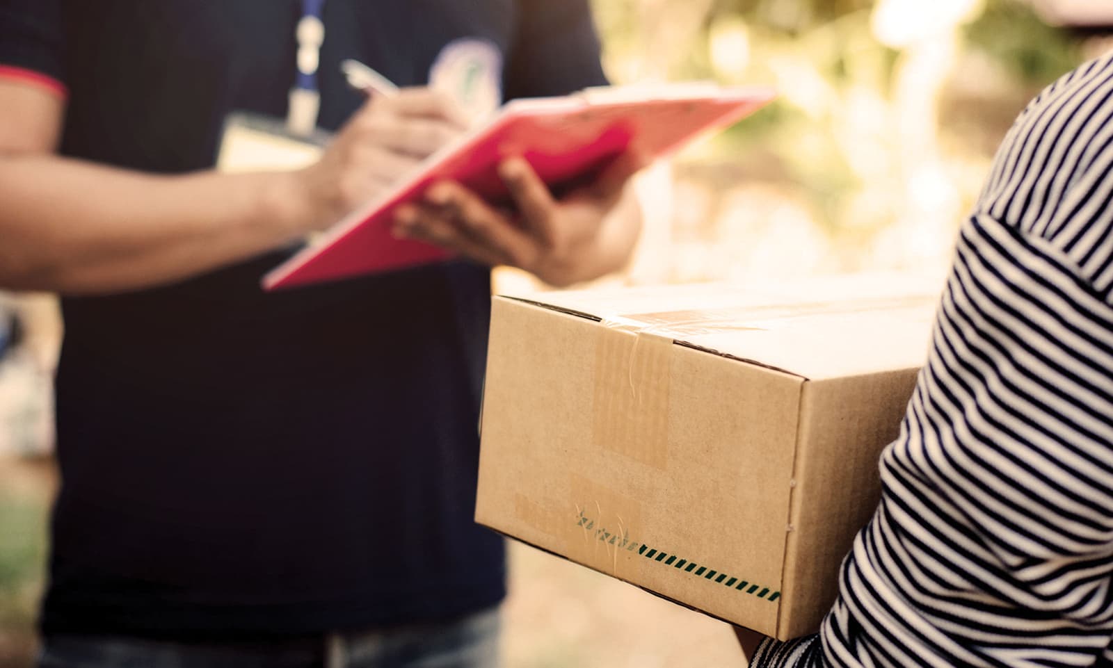 Last mile delivery driver handing a package to a customer